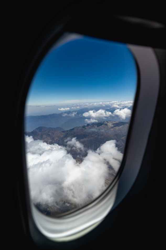mountains and clouds outside of an airplane window