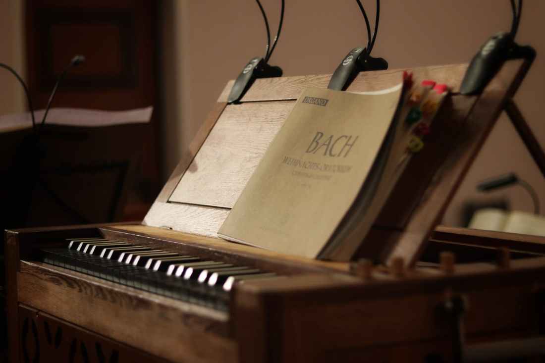 brown booklet in a brown wooden piano close up photography